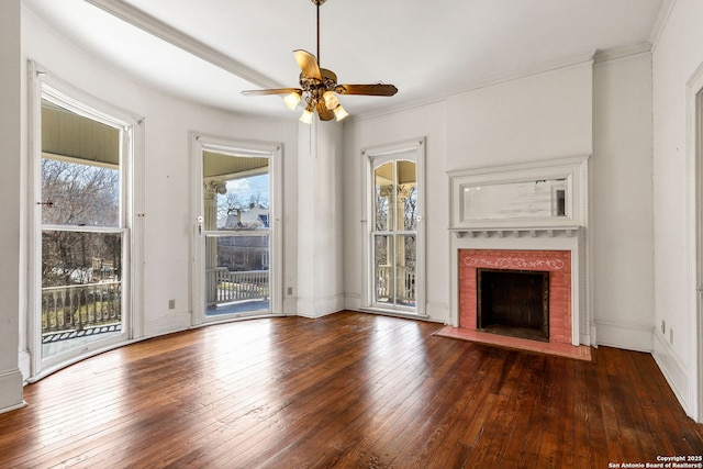 unfurnished living room with a brick fireplace, crown molding, a ceiling fan, and hardwood / wood-style floors