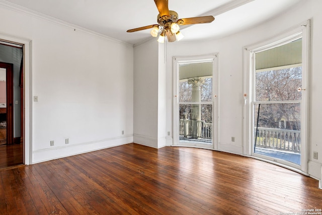 empty room with ornamental molding, baseboards, ceiling fan, and hardwood / wood-style floors