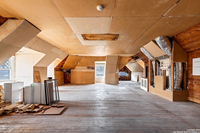 additional living space featuring lofted ceiling and wood-type flooring