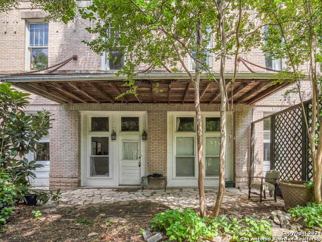 doorway to property featuring brick siding