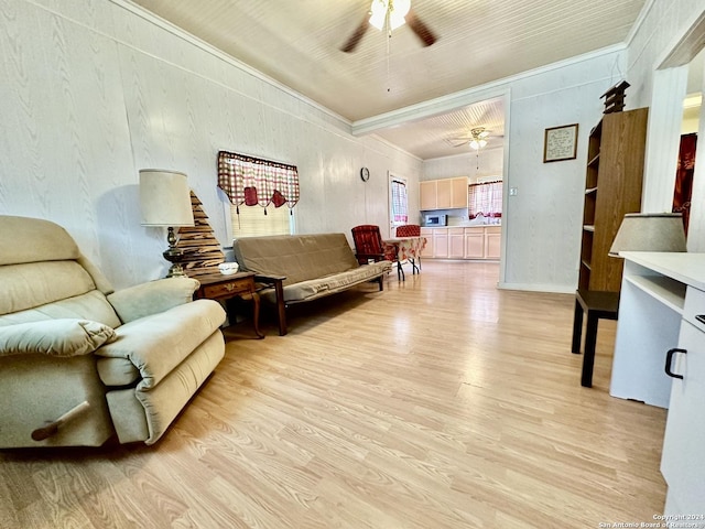 living room featuring ceiling fan, light hardwood / wood-style floors, and crown molding