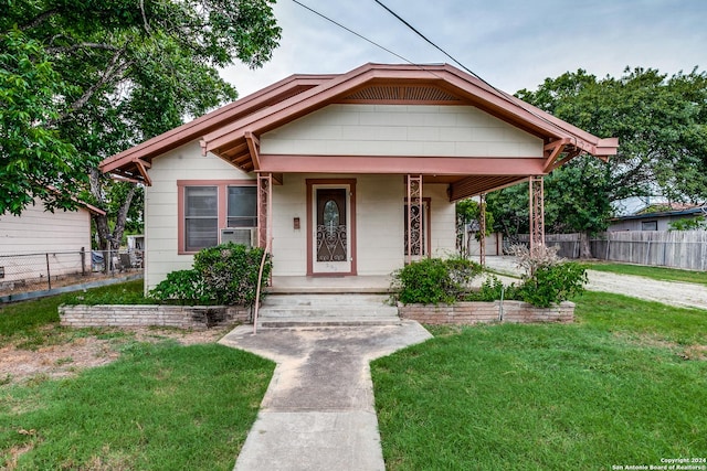 bungalow-style home with a front yard
