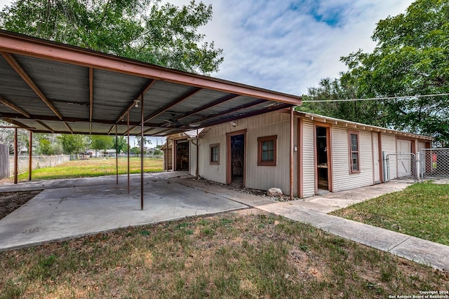 view of car parking with ceiling fan and a yard