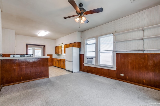 kitchen with white fridge, cooling unit, light colored carpet, and ceiling fan