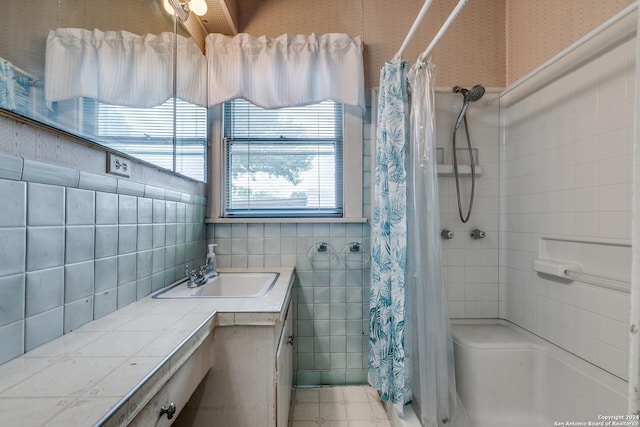 bathroom with vanity and tile walls