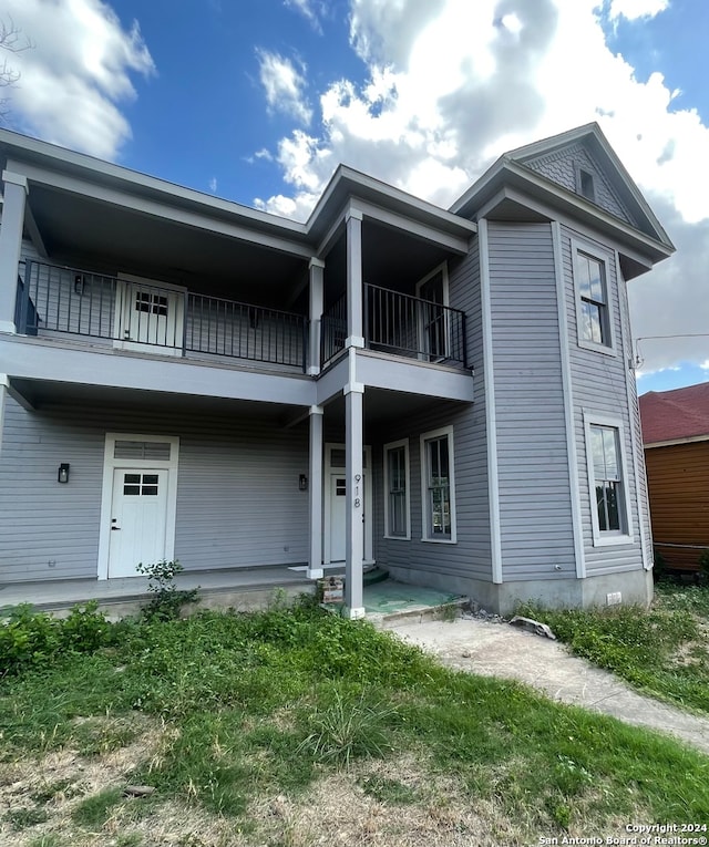 back of house with a balcony