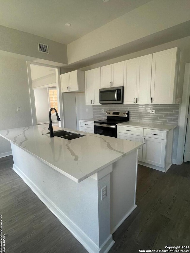 kitchen featuring appliances with stainless steel finishes, white cabinets, sink, and dark hardwood / wood-style floors