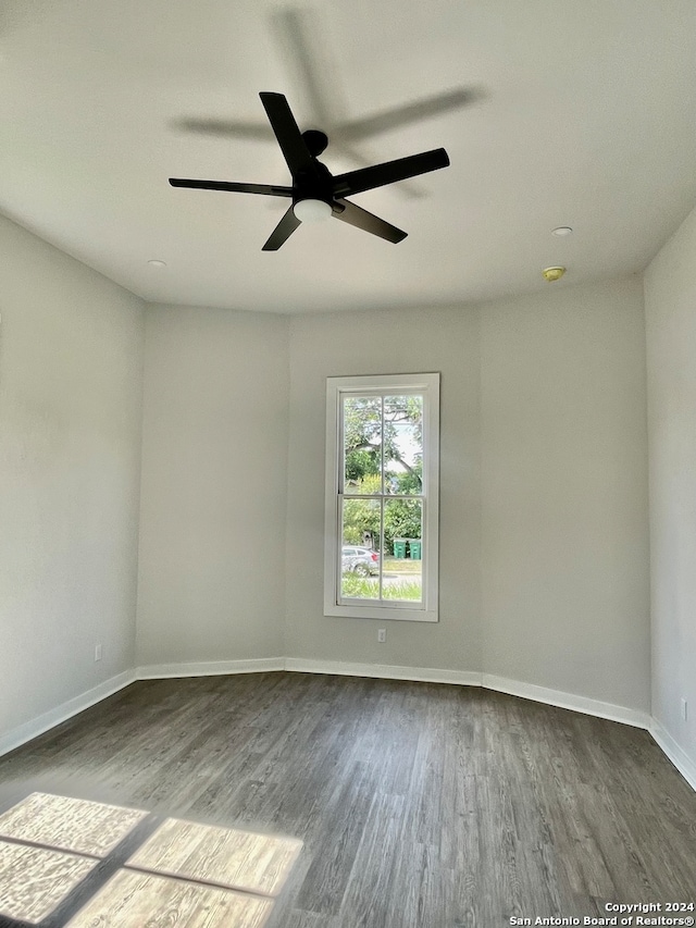 empty room featuring hardwood / wood-style flooring and ceiling fan