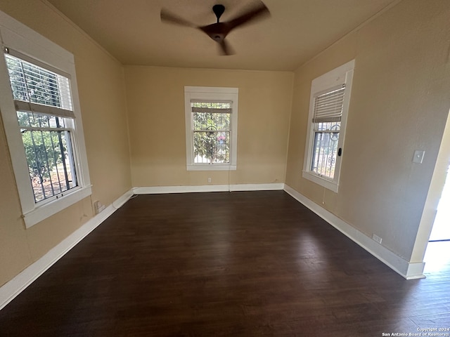 spare room featuring dark hardwood / wood-style floors and ceiling fan