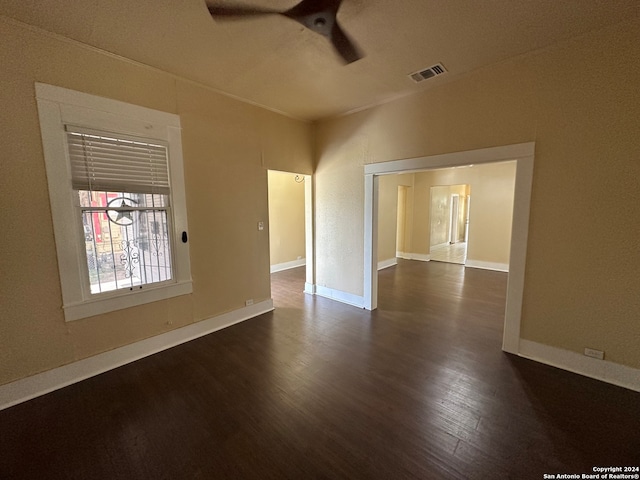 empty room with ceiling fan and dark wood-type flooring