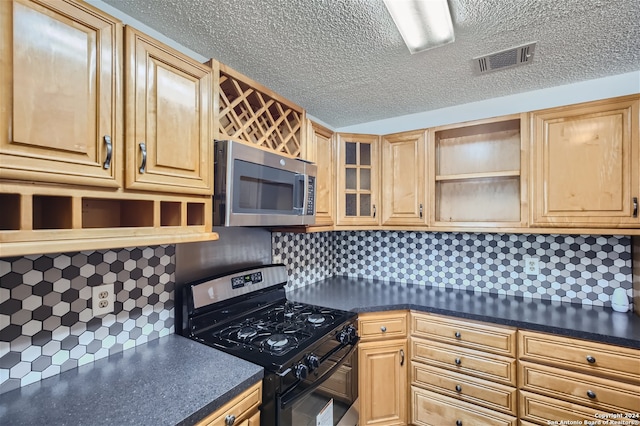 kitchen with a textured ceiling, tasteful backsplash, and black range with gas cooktop