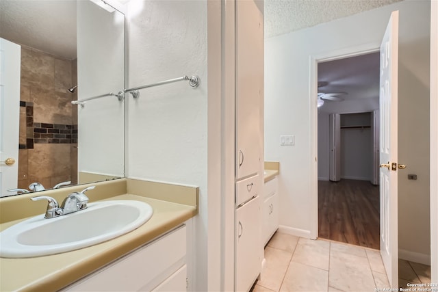 bathroom featuring vanity, a textured ceiling, tile patterned floors, and ceiling fan