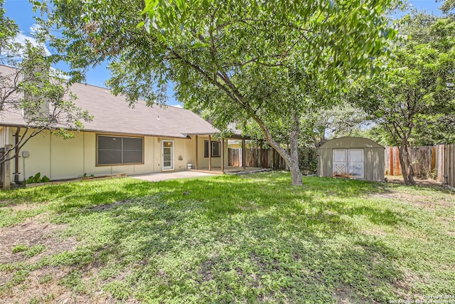 view of yard with a storage shed and a patio area