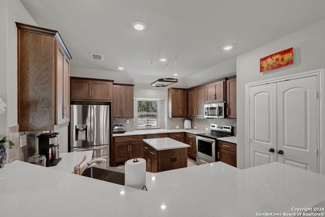 120 Sierra Way, Canyon Lake, TX 78133 - kitchen featuring stainless steel appliances, a kitchen island, and tasteful backsplash