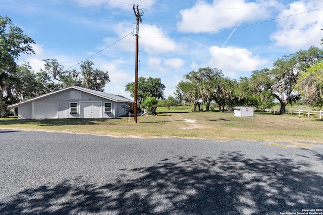 exterior space with a garage, an outdoor structure, and a yard