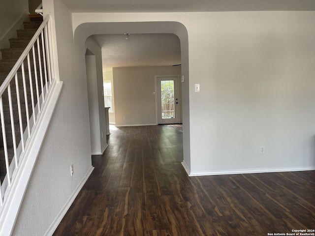 hallway with dark hardwood / wood-style flooring