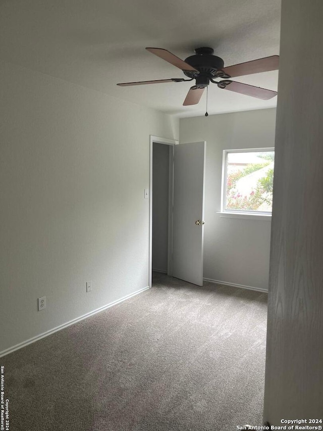 spare room with ceiling fan and carpet floors