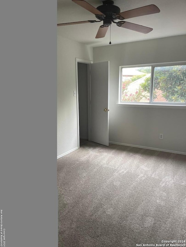 unfurnished room featuring carpet and ceiling fan