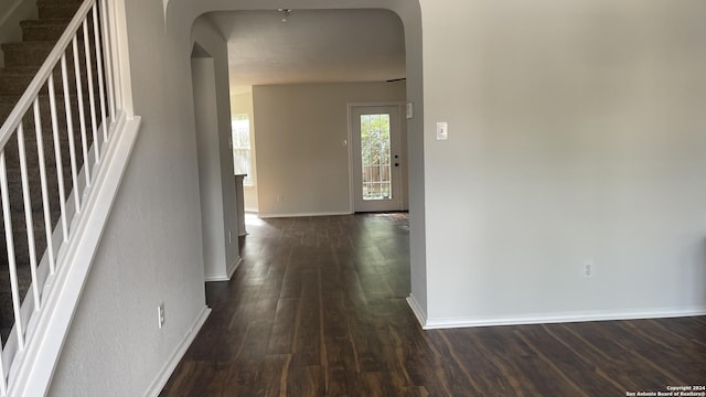 corridor with dark hardwood / wood-style flooring