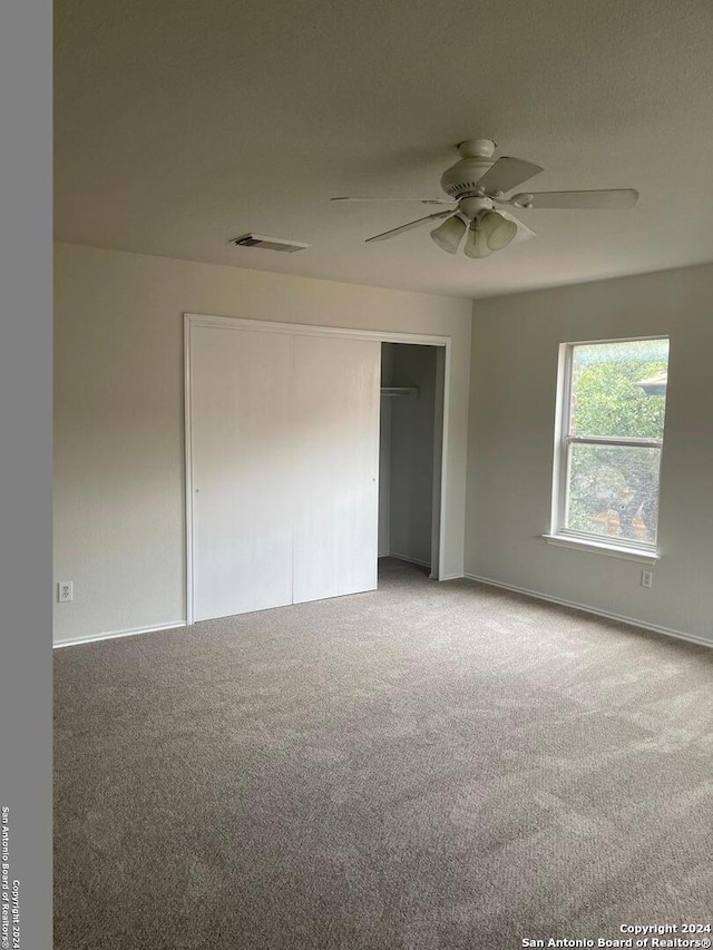 unfurnished room featuring carpet floors and ceiling fan