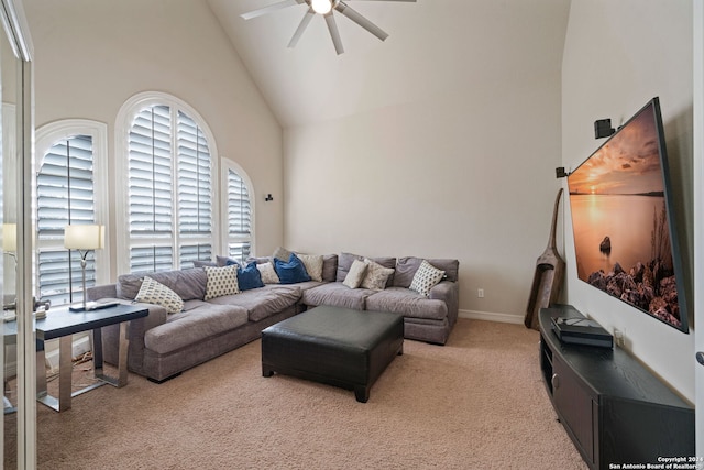 carpeted living room featuring ceiling fan and high vaulted ceiling