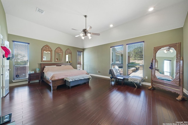 bedroom featuring dark wood-type flooring, vaulted ceiling, and ceiling fan