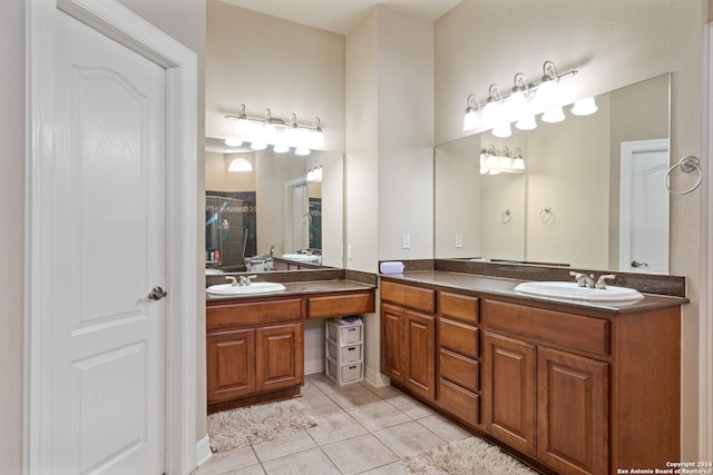 bathroom featuring walk in shower, vanity, and tile patterned floors