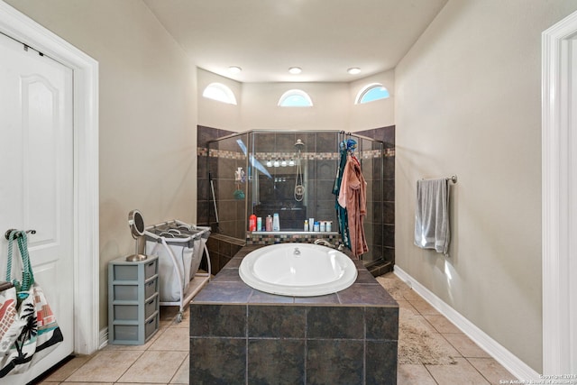 bathroom with plus walk in shower and tile patterned flooring