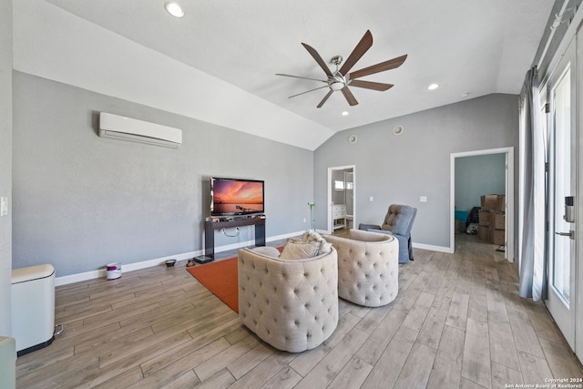 living room featuring vaulted ceiling, a wall unit AC, light hardwood / wood-style flooring, and ceiling fan