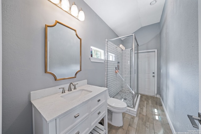 bathroom with an enclosed shower, hardwood / wood-style floors, toilet, vaulted ceiling, and vanity