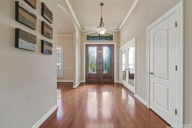 foyer with french doors, hardwood / wood-style flooring, and ornamental molding