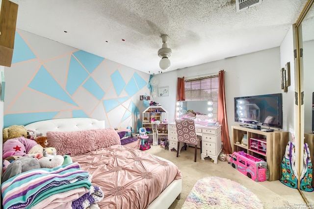 carpeted bedroom featuring ceiling fan and a textured ceiling