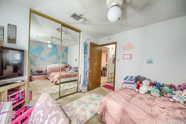 carpeted bedroom featuring a textured ceiling and a closet