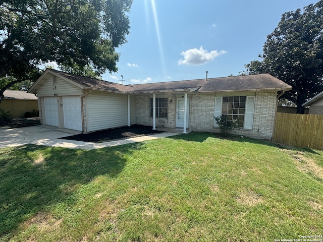 single story home featuring a garage and a front lawn