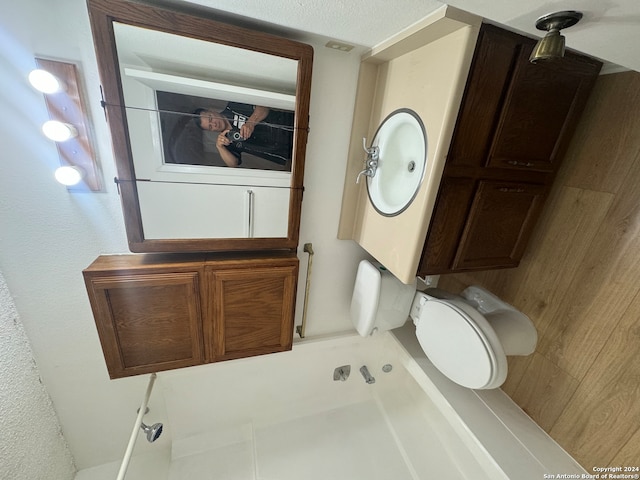 bathroom with toilet and wooden walls