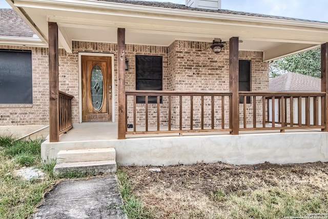 view of exterior entry featuring a porch