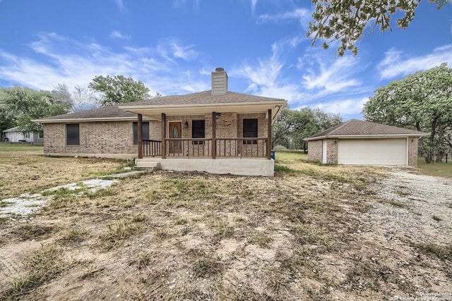 view of front of property featuring an outbuilding, covered porch, and a garage