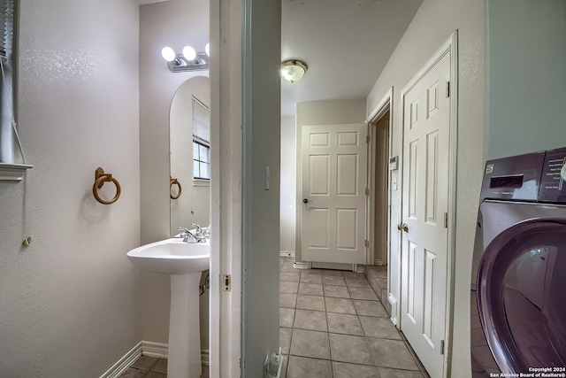 bathroom with washer / dryer and tile patterned floors