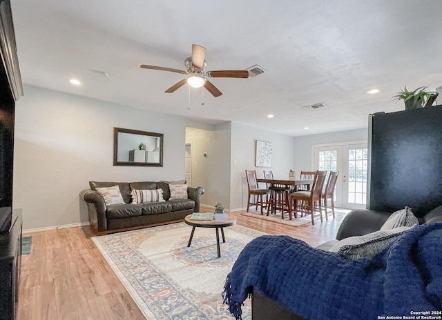 living room featuring french doors, light wood-type flooring, and ceiling fan