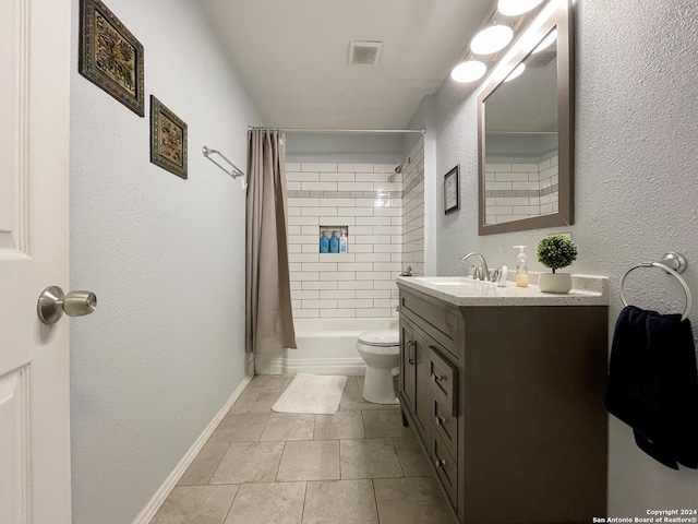 full bathroom with tile patterned floors, shower / bath combo with shower curtain, vanity, and toilet