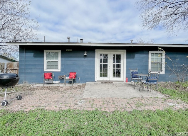 back of property with a patio area and french doors