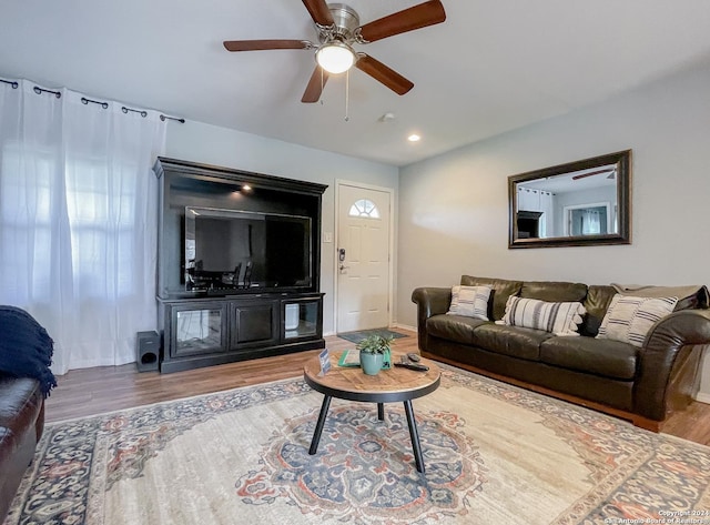 living room featuring ceiling fan and hardwood / wood-style floors