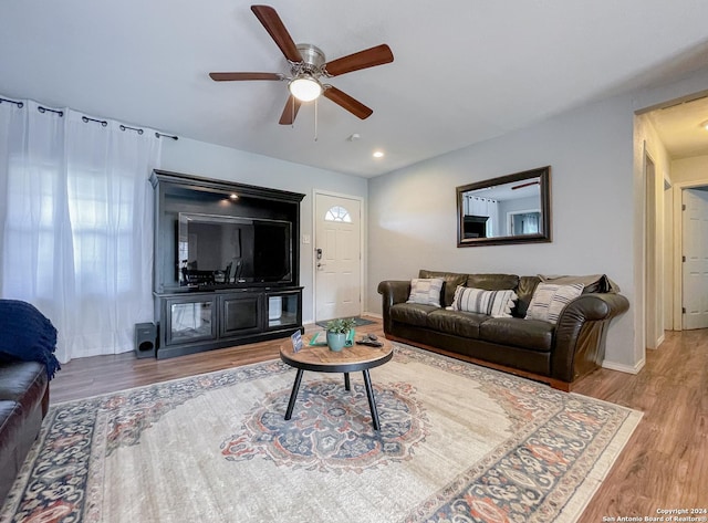 living room with ceiling fan and wood-type flooring