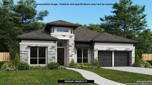 view of front of home with a front lawn and a garage