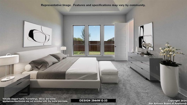 carpeted bedroom with a tray ceiling