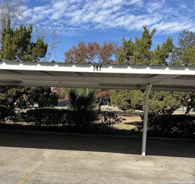 view of vehicle parking with a carport