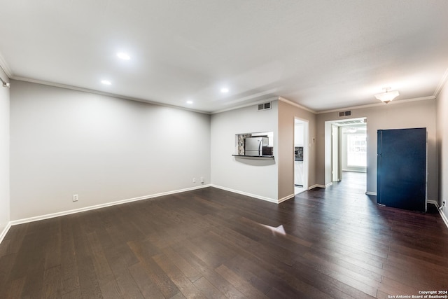 unfurnished living room featuring ornamental molding and dark hardwood / wood-style floors