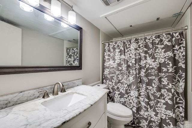 bathroom featuring toilet and vanity