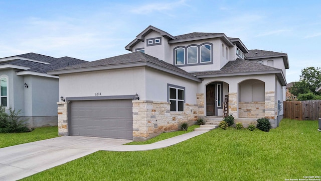 view of front of home with a front yard and a garage