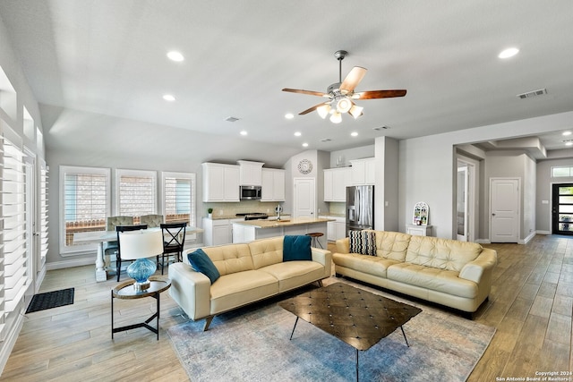 living room featuring ceiling fan and sink